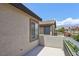 Private balcony offers a cozy outdoor space with views of neighboring houses and clear blue sky at 8204 Chimney Bluffs St, North Las Vegas, NV 89085