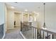 Upstairs hallway with decorative railing and elegant chandelier, offering a bright and inviting transition space at 8204 Chimney Bluffs St, North Las Vegas, NV 89085
