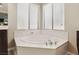 Close-up of the main bathroom bathtub featuring a jacuzzi, window, and chrome faucet at 8204 Chimney Bluffs St, North Las Vegas, NV 89085