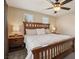 The spacious main bedroom features large bed, side tables, lamps and a ceiling fan at 8204 Chimney Bluffs St, North Las Vegas, NV 89085
