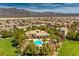 Stunning aerial view of a well-maintained neighborhood with a central pool and mountain backdrop at 8224 Fowler Falls Ct, North Las Vegas, NV 89085