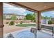 Relaxing covered patio offers a tranquil view of the landscaped backyard at 8224 Fowler Falls Ct, North Las Vegas, NV 89085