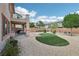 Backyard featuring gravel, artificial turf, brick patio and covered patio at 8224 Fowler Falls Ct, North Las Vegas, NV 89085