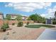 Landscaped backyard featuring brick border, gravel, turf, and mature trees at 8224 Fowler Falls Ct, North Las Vegas, NV 89085