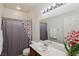 Bathroom featuring a sink, shower with floral curtain, and a large mirror at 8224 Fowler Falls Ct, North Las Vegas, NV 89085
