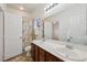 Bathroom featuring double sinks, large mirror, and shower-tub combo at 8224 Fowler Falls Ct, North Las Vegas, NV 89085