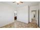 Neutral bedroom featuring ceiling fan, ensuite bathroom, and tile flooring at 8224 Fowler Falls Ct, North Las Vegas, NV 89085