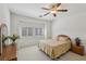 Bright bedroom with a ceiling fan and natural light from shuttered windows at 8224 Fowler Falls Ct, North Las Vegas, NV 89085