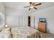 Bedroom features a ceiling fan, closet, television, and carpet at 8224 Fowler Falls Ct, North Las Vegas, NV 89085
