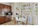 Breakfast nook with white table, upholstered chairs, and shuttered windows at 8224 Fowler Falls Ct, North Las Vegas, NV 89085