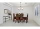 Dining room featuring carved wooden table and chairs, and elegant lighting fixture at 8224 Fowler Falls Ct, North Las Vegas, NV 89085