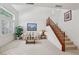 Bright living room featuring comfortable seating and staircase at 8224 Fowler Falls Ct, North Las Vegas, NV 89085