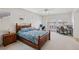 Spacious bedroom with wooden furniture, ceiling fan, and natural light from the windows at 8224 Fowler Falls Ct, North Las Vegas, NV 89085