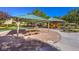 Covered gazebo with picnic tables at a park and a colorful playground at 8224 Fowler Falls Ct, North Las Vegas, NV 89085