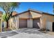 Home's exterior with a two car garage, tiled roof, and low maintenance landscaping at 8560 Alocasia Ct, Las Vegas, NV 89149