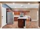 Gourmet kitchen featuring a large island, stainless steel appliances, and wood-look tile flooring at 8560 Alocasia Ct, Las Vegas, NV 89149