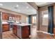 Bright kitchen featuring a center island, stainless steel appliances, and wood-look tile flooring at 8560 Alocasia Ct, Las Vegas, NV 89149