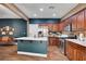 Spacious kitchen boasting stainless steel appliances, a center island, and wood-look tile flooring at 8560 Alocasia Ct, Las Vegas, NV 89149