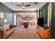 Open-concept living space with wood-look tile floors and a large kitchen island at 8560 Alocasia Ct, Las Vegas, NV 89149