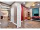 Open hallway leading to living room and kitchen with wood look tile flooring throughout at 8560 Alocasia Ct, Las Vegas, NV 89149