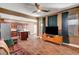 View of the open-concept living room showing the kitchen, wood-look tile floors, and ceiling fan at 8560 Alocasia Ct, Las Vegas, NV 89149