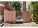 A gated entry leads to a cozy backyard with desert landscaping and string lights for evening enjoyment at 9053 Boston Springs Ave, Las Vegas, NV 89149