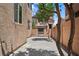 Private backyard with decorative string lights, charming tree accents, and a secure gated area at 9053 Boston Springs Ave, Las Vegas, NV 89149