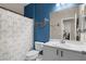 Charming bathroom with a blue accent wall, whale decoration, and patterned shower curtain at 9053 Boston Springs Ave, Las Vegas, NV 89149