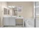 Spacious bathroom with a soaking tub, vanity, and bright lighting, perfect for relaxation at 9053 Boston Springs Ave, Las Vegas, NV 89149