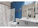 Charming bathroom with a blue accent wall, whale decoration, and neutral-colored shower curtain at 9053 Boston Springs Ave, Las Vegas, NV 89149