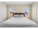 Bright bedroom featuring a comfortable bed, neutral walls, and natural light from two windows at 9053 Boston Springs Ave, Las Vegas, NV 89149