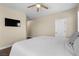 Bedroom with hardwood floors, ceiling fan and wall-mounted television at 9053 Boston Springs Ave, Las Vegas, NV 89149