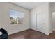 Bright bedroom with hardwood floors, a closet, and natural light from a large window at 9053 Boston Springs Ave, Las Vegas, NV 89149