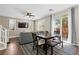 Cozy dining area featuring a dark wood table, stylish rug, and direct access to the backyard through sliding doors at 9053 Boston Springs Ave, Las Vegas, NV 89149