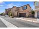 Attractive two-story home featuring a two-car garage, desert landscaping and inviting curb appeal at 9053 Boston Springs Ave, Las Vegas, NV 89149