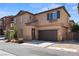 A beautifully designed home featuring desert landscaping, a two-car garage, and an inviting entrance at 9053 Boston Springs Ave, Las Vegas, NV 89149