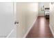 Hallway with hardwood floors leading to a bedroom with a neutral color palette at 9053 Boston Springs Ave, Las Vegas, NV 89149