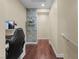 Second floor hallway with hardwood floors and decorated nook leading to a bedroom at 9053 Boston Springs Ave, Las Vegas, NV 89149