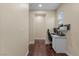 Hallway with hardwood floors leading to a bedroom that is set up as a home office at 9053 Boston Springs Ave, Las Vegas, NV 89149