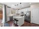 Modern white kitchen with stainless steel appliances, sleek countertops, and a stylish center island at 9053 Boston Springs Ave, Las Vegas, NV 89149