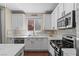 Beautiful kitchen featuring stainless steel appliances, ample counter space, and modern white cabinetry at 9053 Boston Springs Ave, Las Vegas, NV 89149