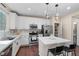 Modern kitchen boasts quartz counters, stainless appliances, white cabinetry, and a convenient island at 9053 Boston Springs Ave, Las Vegas, NV 89149