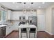 Modern kitchen boasts quartz counters, stainless appliances, white cabinetry, and a convenient island at 9053 Boston Springs Ave, Las Vegas, NV 89149