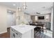 Open-concept kitchen and dining area with a white island, perfect for entertaining, in a modern home at 9053 Boston Springs Ave, Las Vegas, NV 89149