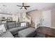 Inviting living space featuring an open floor plan, a comfortable gray sectional sofa, and a view of the modern kitchen at 9053 Boston Springs Ave, Las Vegas, NV 89149