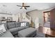 Inviting living space featuring an open floor plan, a comfortable gray sectional sofa, and a view of the modern kitchen at 9053 Boston Springs Ave, Las Vegas, NV 89149