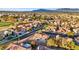 A high aerial view captures a charming neighborhood nestled beside a golf course with mountain views at 9105 Marble Dr, Las Vegas, NV 89134