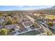 Scenic aerial view of a neighborhood with well-maintained homes, lush landscaping, and a picturesque mountain backdrop at 9105 Marble Dr, Las Vegas, NV 89134