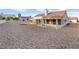 Exterior view of a home's backyard showcasing its desert landscaping and covered patio area at 9105 Marble Dr, Las Vegas, NV 89134
