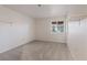 Bedroom with neutral carpet, a window and white walls with an open shelf at 9105 Marble Dr, Las Vegas, NV 89134